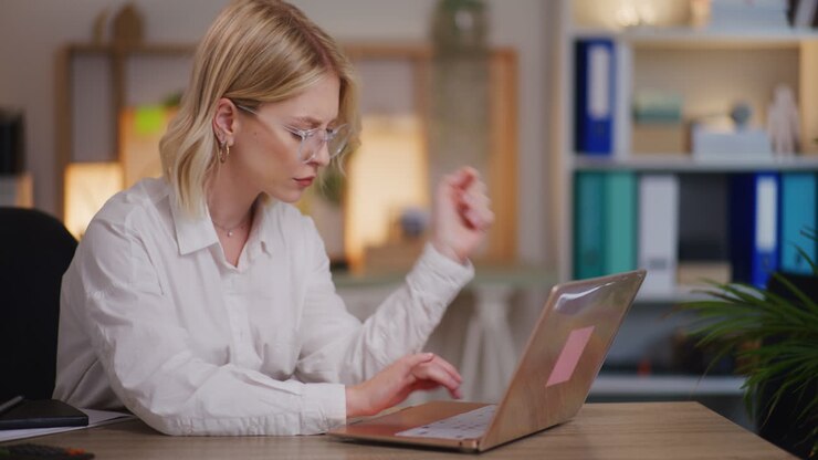 Worried Overworked Woman Working on Laptop in Evening