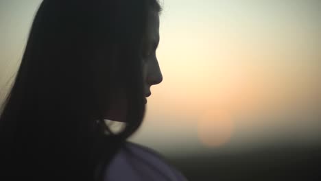 close up shot of a brunette girl during sunset or sunrise