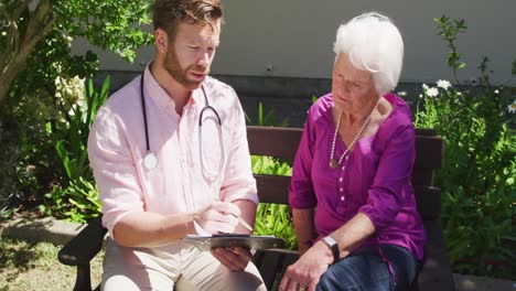 Doctor-with-a-senior-woman-in-the-park-of-a-retirement-home