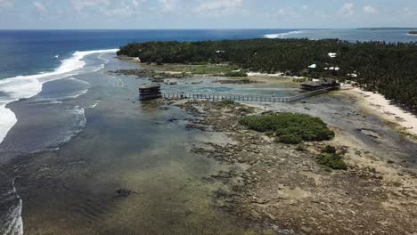 pullback aerial view across cloud 9 siargao under low tide