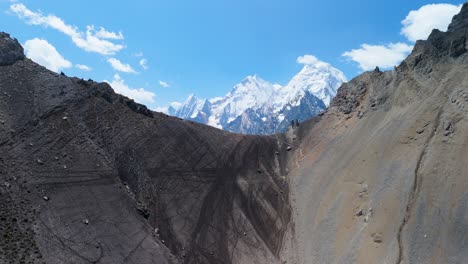 dynamic aerial flying forward over the high-altitude san antonio pass reveals sweeping glacial valleys and the dramatic snow-capped peaks of the cordillera huayhuash in peru
