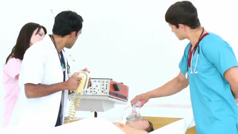 doctors resuscitating a little boy with a defibrillator