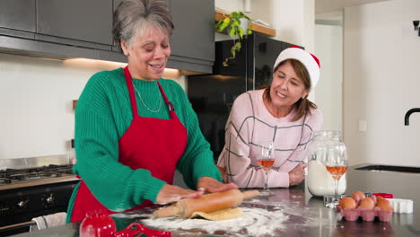 at christmas, senior women baking together in kitchen, enjoying festive holiday spirit