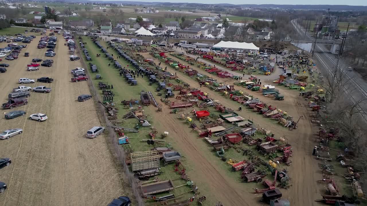 High Aerial View of an Amish Mud Sale Auctioning Buggies, Farm Equipment to Quilts on a Winter Day