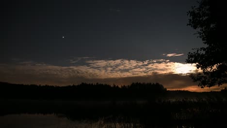 Time-lapse-of-full-moon-lit-night-clouds-and-an-airplane-flying-by-in-dark-starry-sky-making-shooting-star-effect