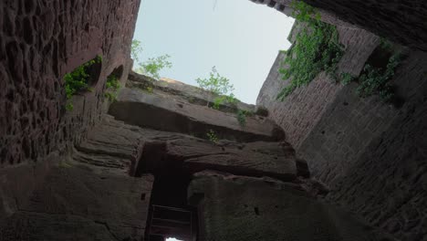 rotating tilted up shot of concrete brick cement walls built up against into mountain side