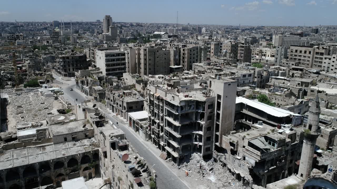 A syrian city from above. Some of the buildings are still in ruins after the civil war 10 years ago - aerial view with a drone 4K