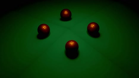 closeup of four red pool balls on a green felt pool table