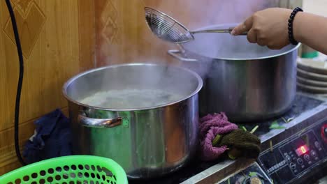sequential steps of boiling clams in a kitchen