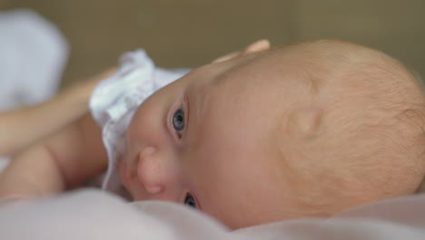 a closeup of a baby girl lying on a belly