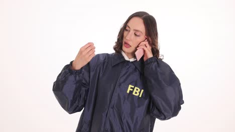 Woman in FBI jacket talking on phone