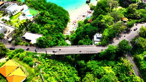 Coastal road and sandy beach in Indonesia, aerial drone view