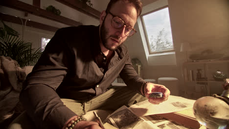 man studying and writing in a home office