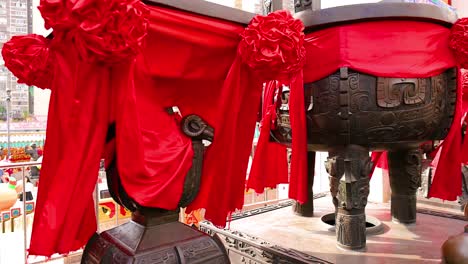 decorated incense burner with vibrant red fabric