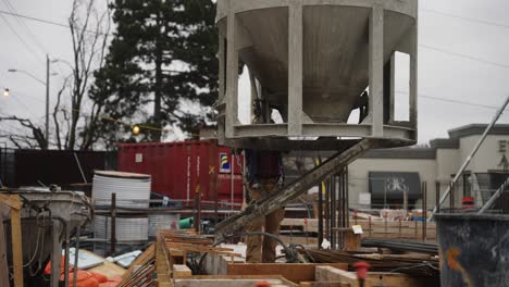 construction worker pouring wet concrete at a construction site in toronto, ontario, canada