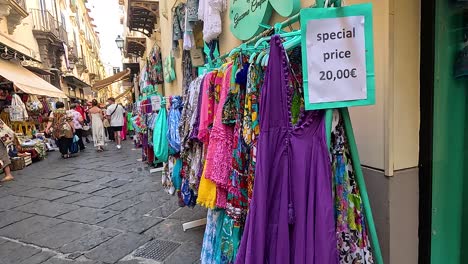 colorful dresses on display in bustling market