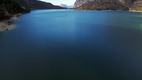 frozen lake between mountains and sky on the horizon