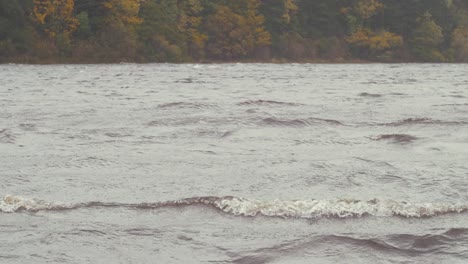 lapping white horse waves on river storm