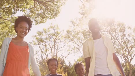 Low-angle-view-of-cute-family-is-holding-by-hands-