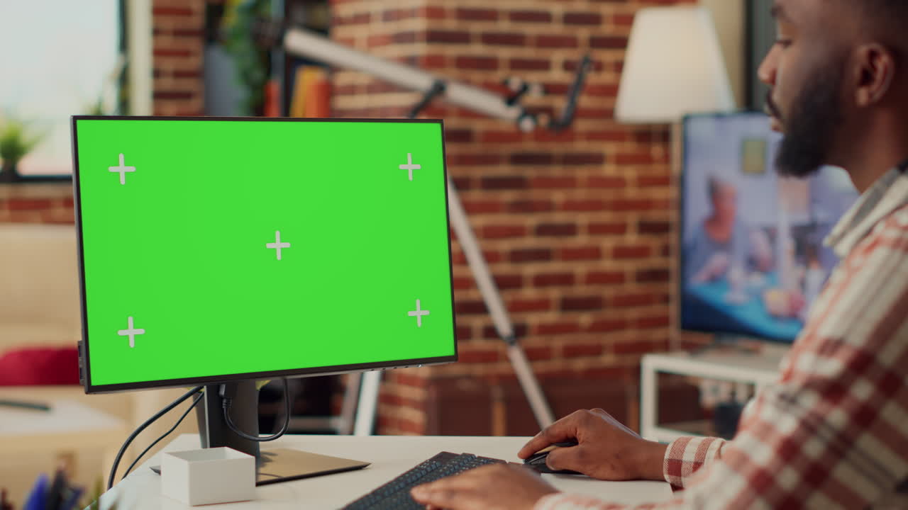 Buisnessman analyzing greenscreen display on monitor