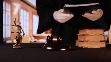 a judge diligently prepares to make an important ruling with a gavel and various legal books in a courtroom setting