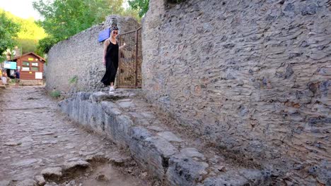 tourist,-girl,-walking,-abandoned-village,-exploration,-adventure,-travel,-kayaköy-in-turkey-fethiye