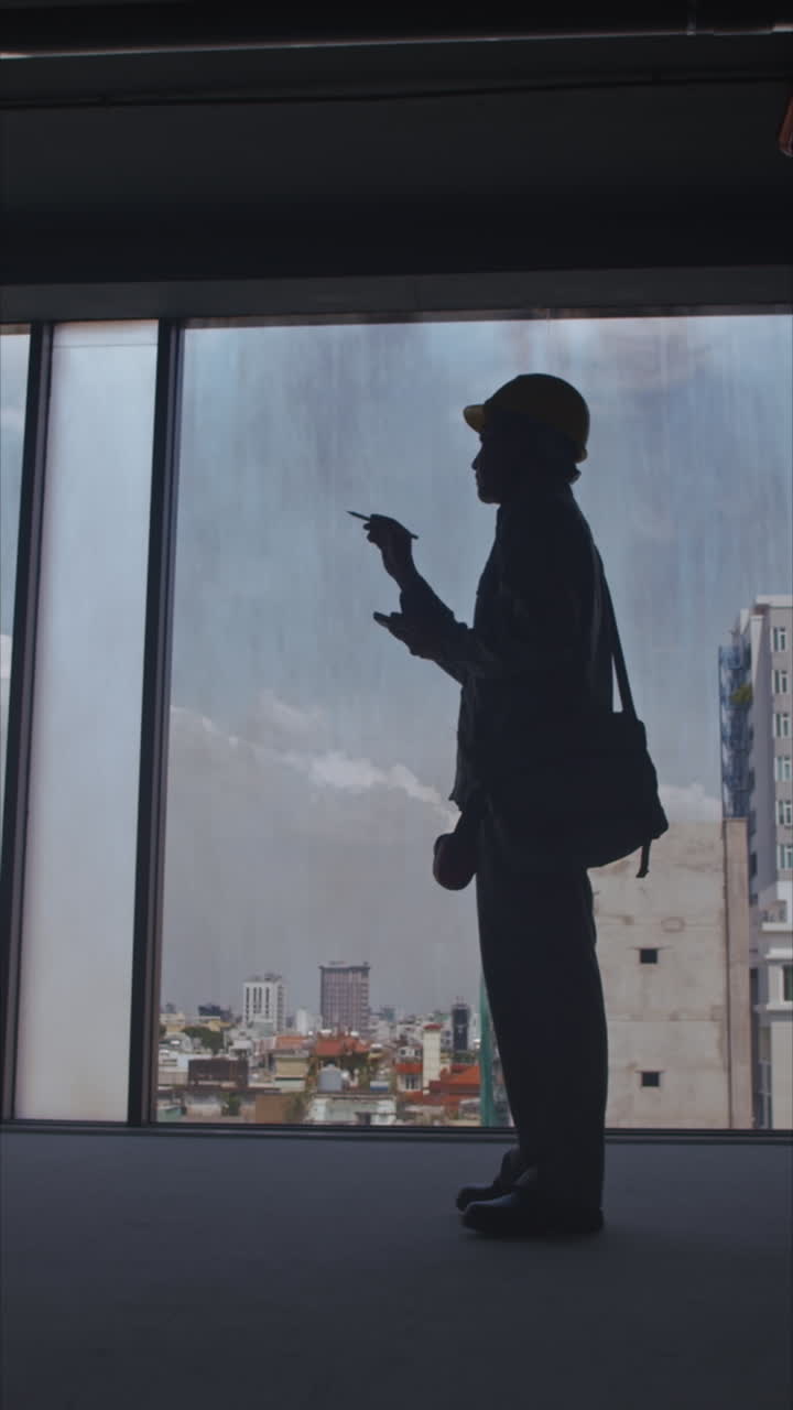 Silhouette of Foreman Inspecting Construction Workspace