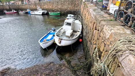 fishing boats docked at a stone pier