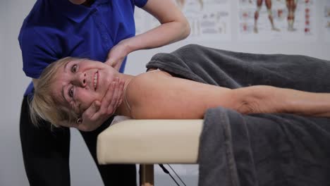 woman receiving neck and shoulder massage from therapist.