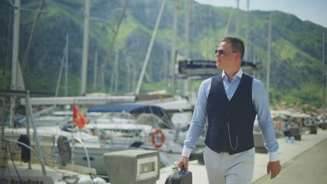 businessman walking at the marina by the sea