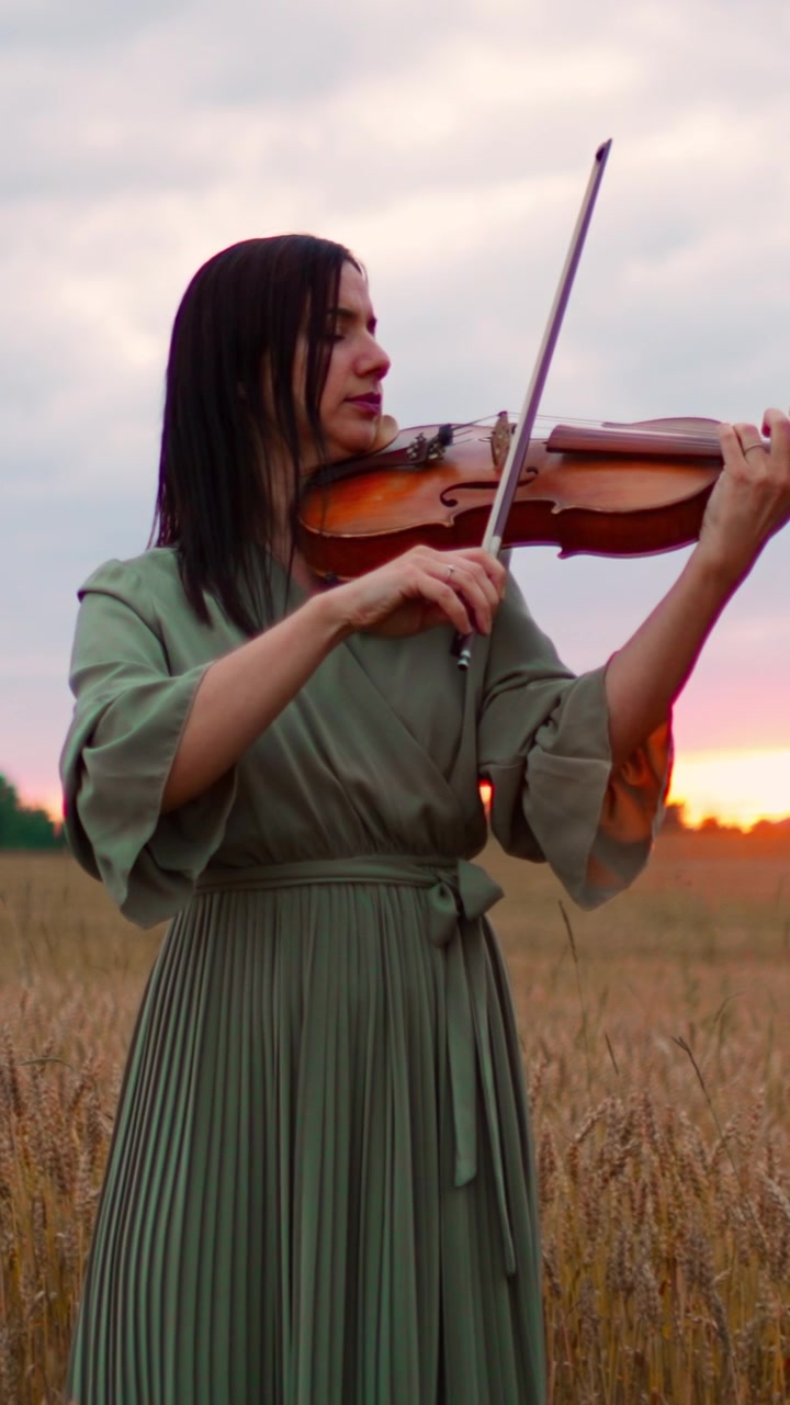 Woman Playing Violin in a Wheat Field at Sunset