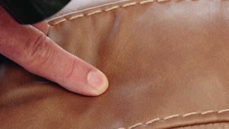 heat gun blasts warm air over glued cut on brown leather in macro view