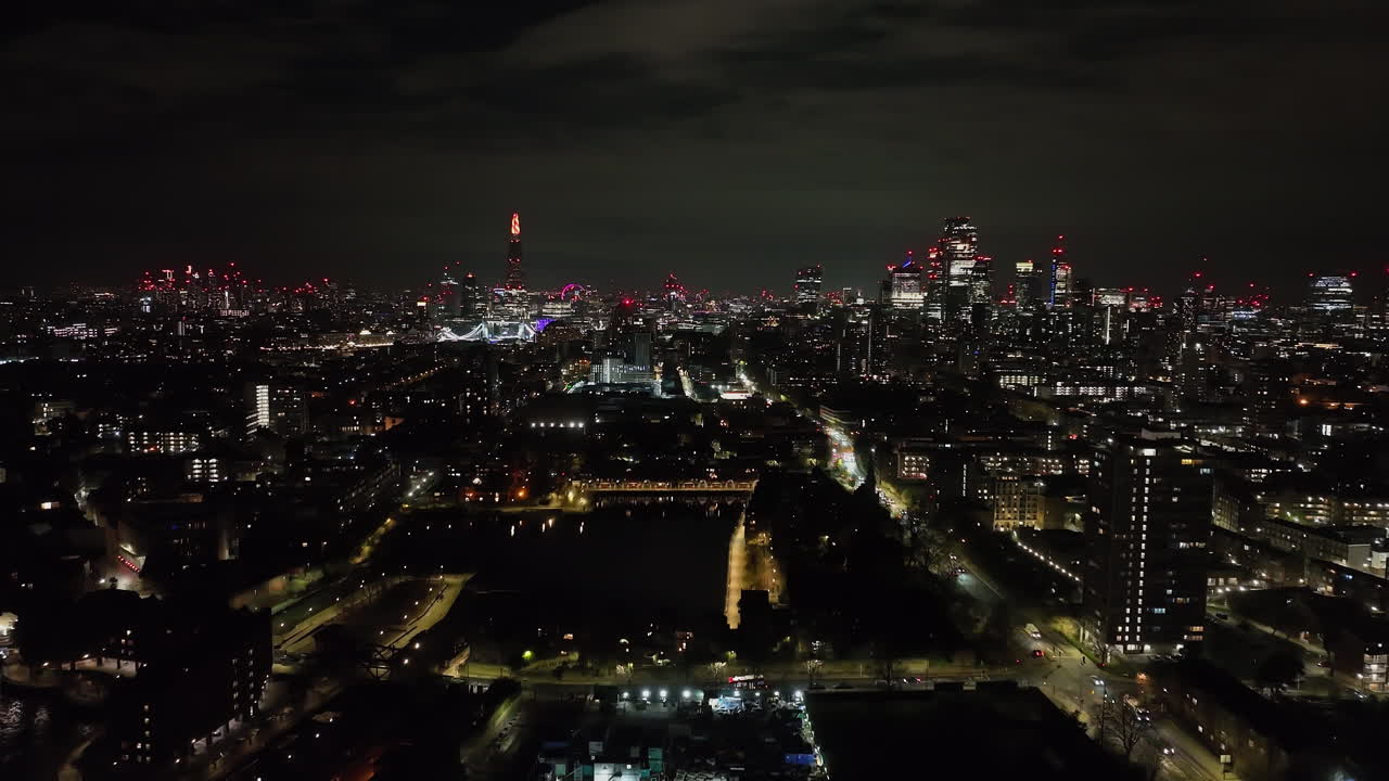 Fixed aerial of traffic at the Shadwell marina and the city of London, night