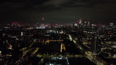 fixed aerial of traffic at the shadwell marina and the city of london, night