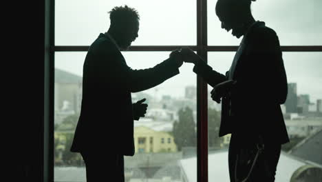 business people talking in front of window