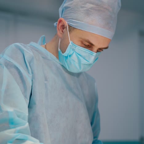 young surgeon performing an operation. doctor and a medical nurse in blue uniform doing a surgery in the operating room in clinic.