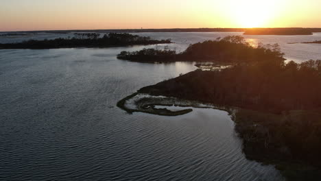 Aerial-shot-of-the-salt-marsh-or-wetlands,-epic-drone-shot-into-the-sun,-slowly-rotating