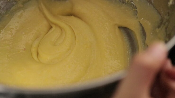 Children making a cake at home, close-up soft focus