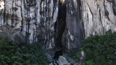 drone footage of a cliff with a huge cave at the chapelle at the reunion island