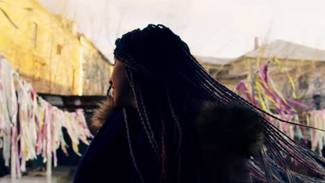 woman with colorful braids in urban setting