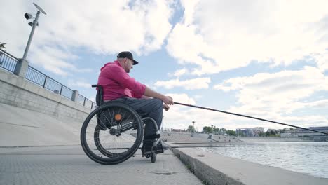 person with a physical disability who uses wheelchair fishing from fishing pier