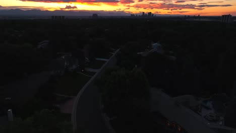 bright orange sunset over housing neighborhood in suburb of american city