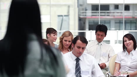 Businessman-stands-up-to-ask-question