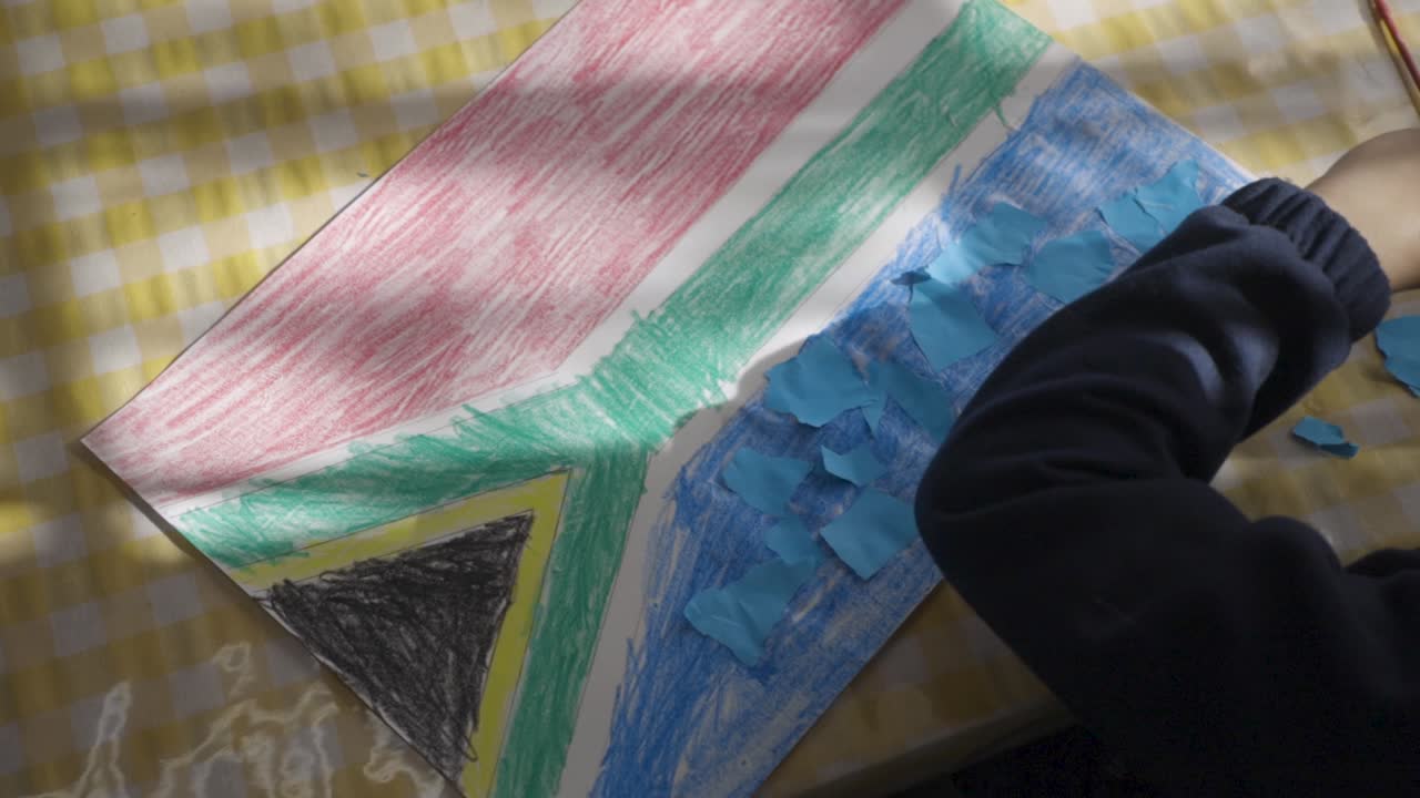 Child's drawing of the South African flag with paper pieces