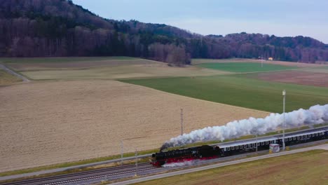 pacific br01 01 202 steam locomotive train traveling cross country in switzerland