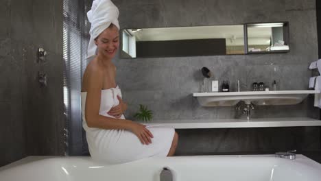 caucasian woman preparing bath in hotel