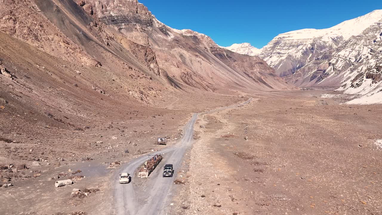 Mountain Road with Trucks and Cars