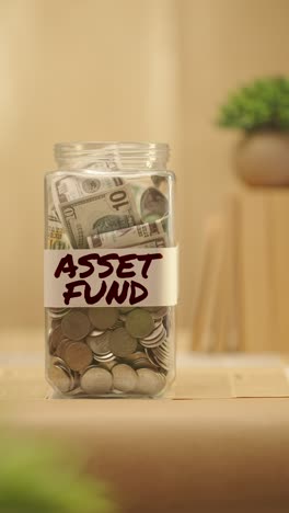 vertical video of person saving money for asset fund
