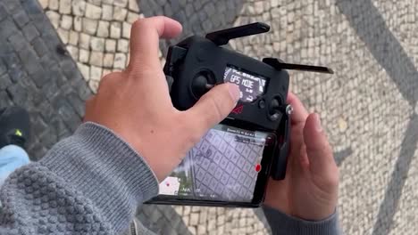 drone pilot rotates joystick of controller giving commands