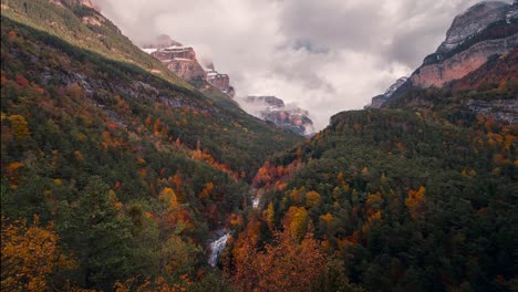 ordesa national park valley on a cloudy and misty winter morning timelapse of clouds rolling over mountain peaks in fall autumn season
